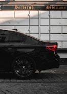A sleek black sedan ready for airport pickup in Gent.