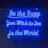 Bright blue neon letters against a dark background spell out an inspirational message in cursive font. The glow of the neon creates a striking contrast with the surroundings.