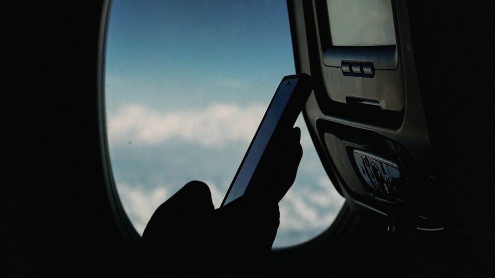 person using smartphone at the airliner