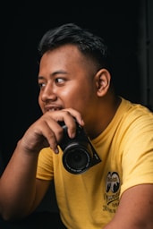 man holding black digital camera