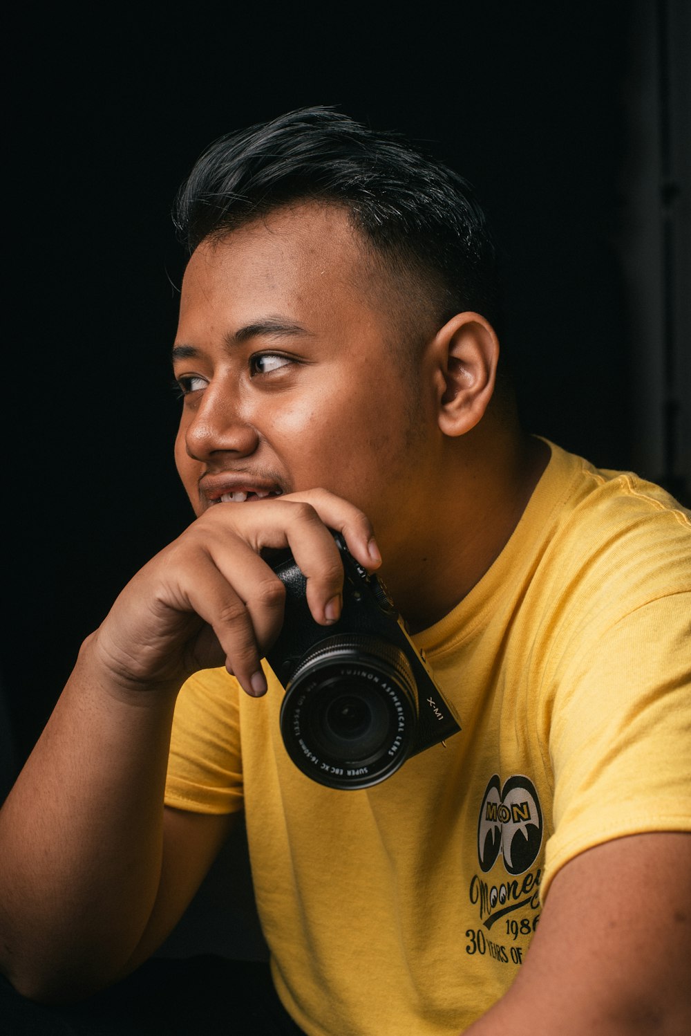 man holding black digital camera