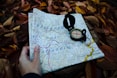 round black compass and white and blue map