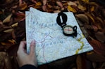 round black compass and white and blue map