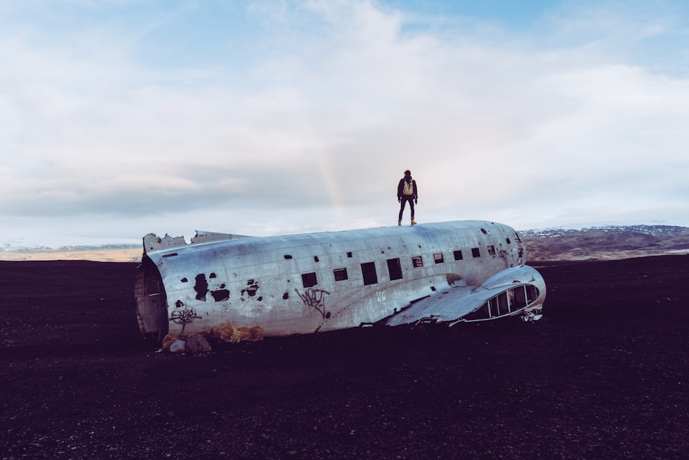 person standing on destroyed airliner