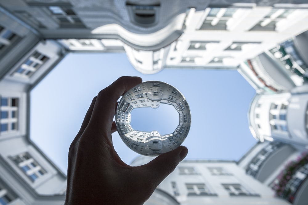 person holding clear stone