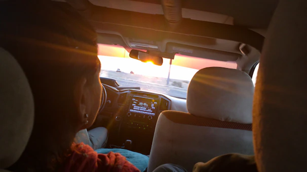 Happy family listening to music on a Vivasonora SRS FM car radio while driving through scenic routes.