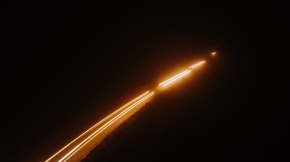 time lapse photo of vehicle light streaks on road