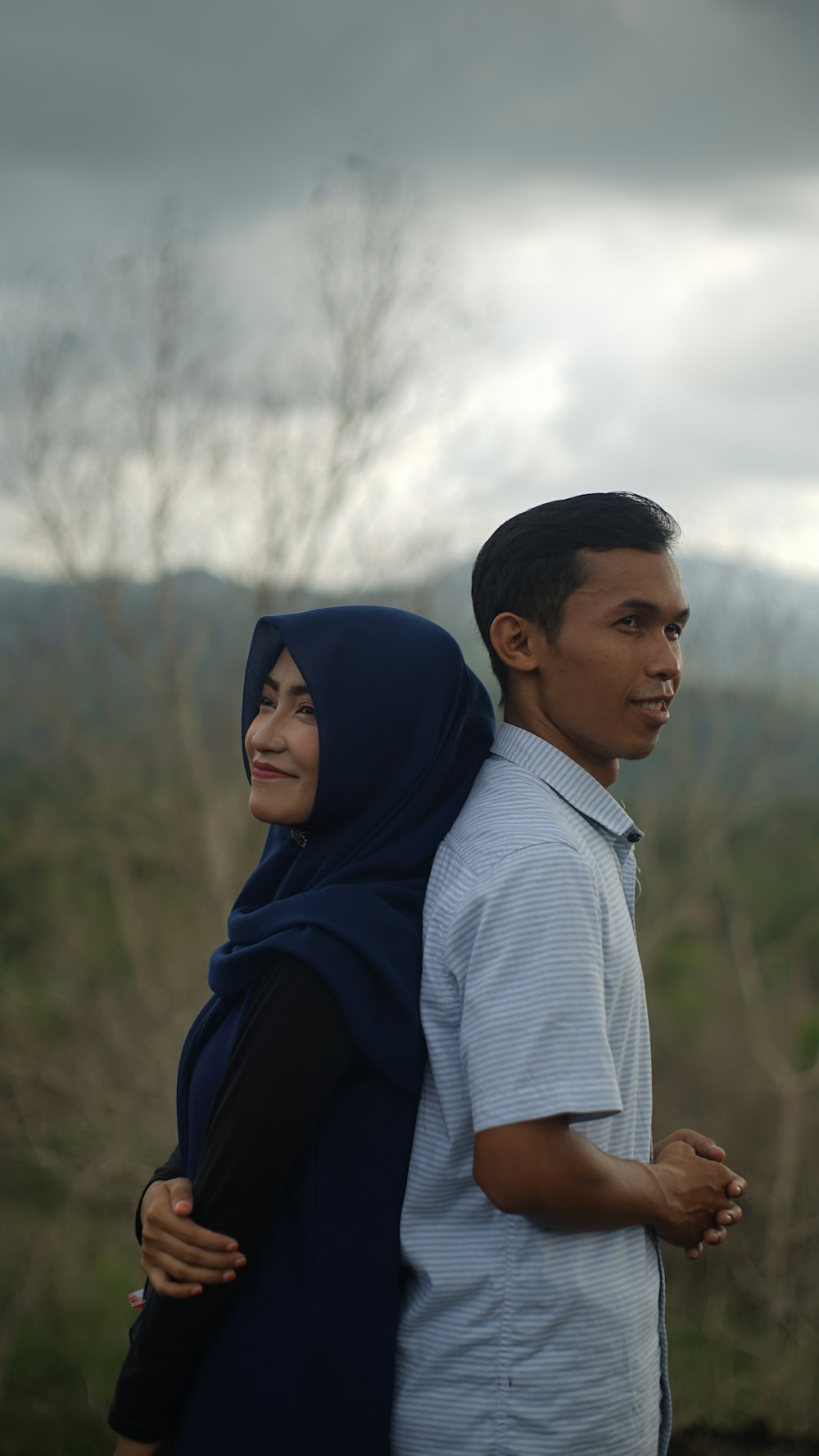 man and woman standing beside grasses