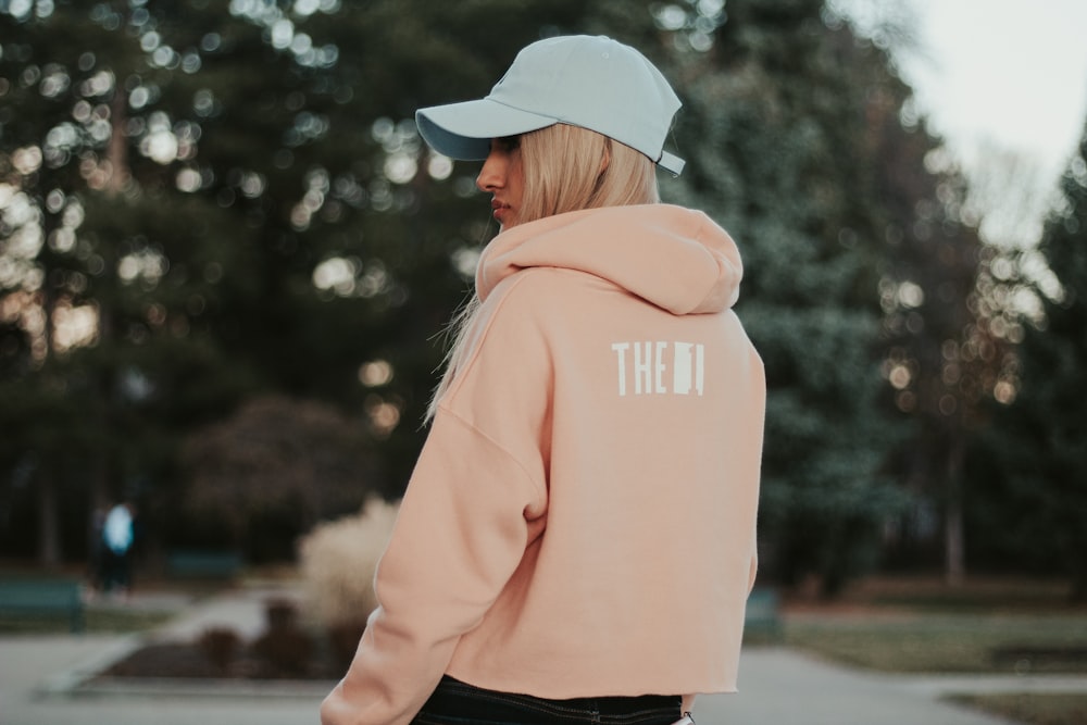 woman wearing orange pullover