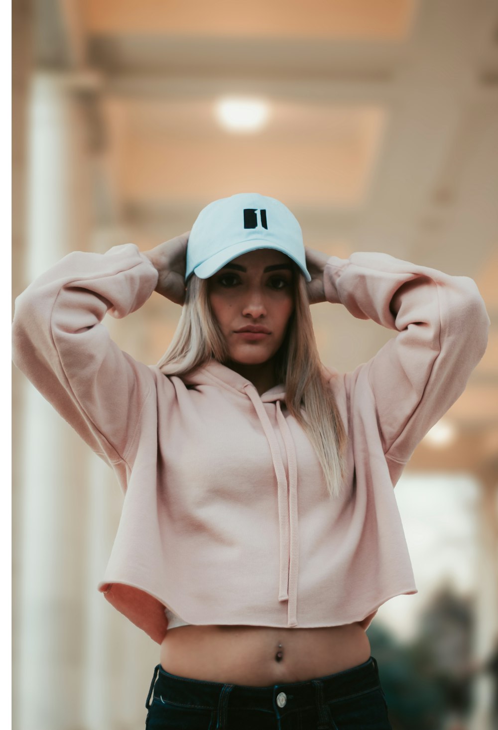 woman wearing pink hoodie and cap