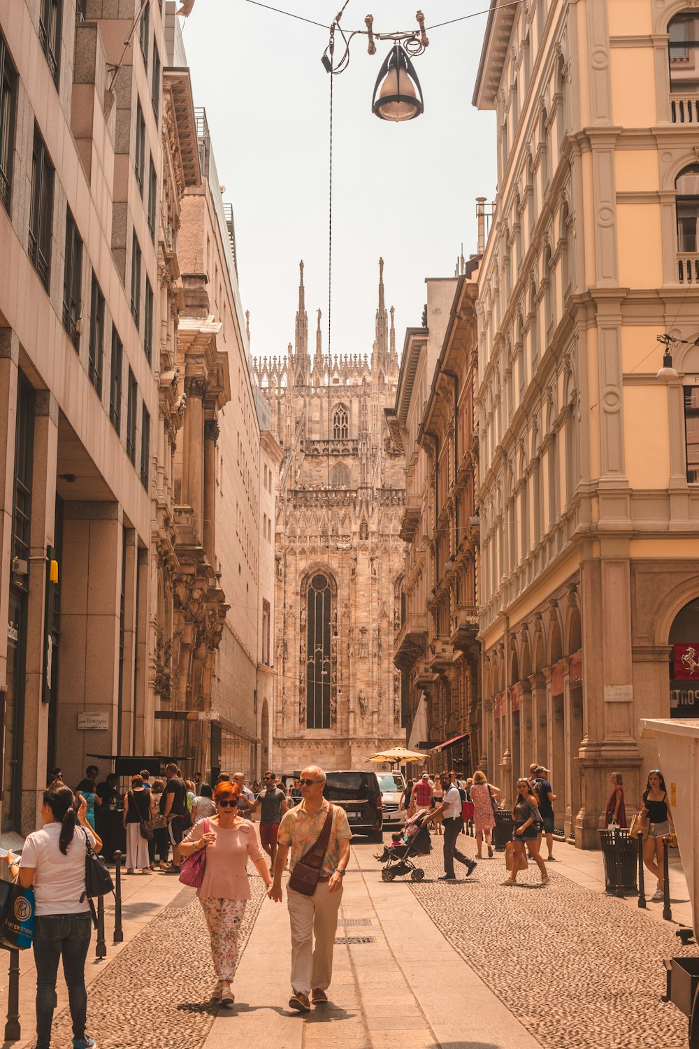 group of people walking on street in between of buildings