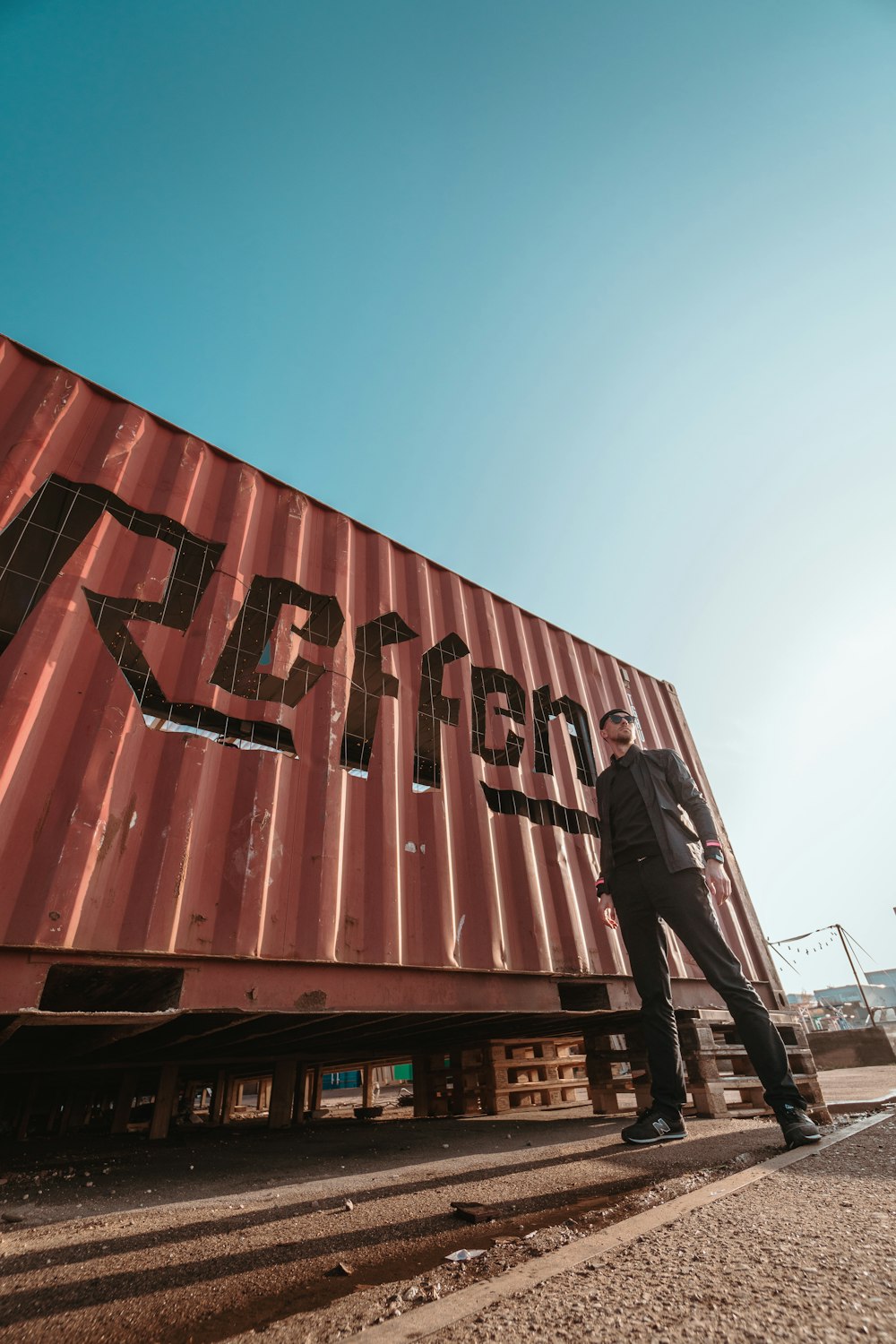 man standing near on read trailer container