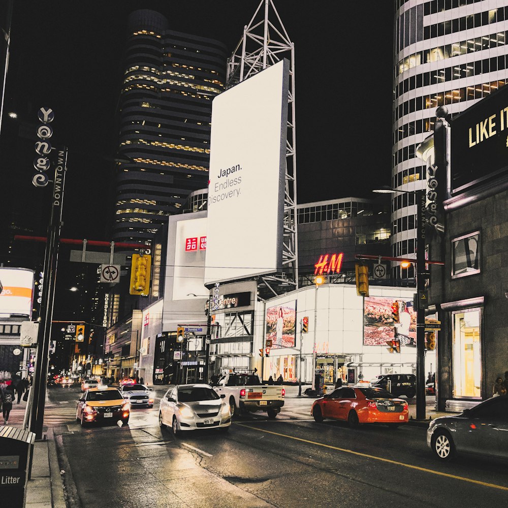 cars parked at sidewalk during nighttime