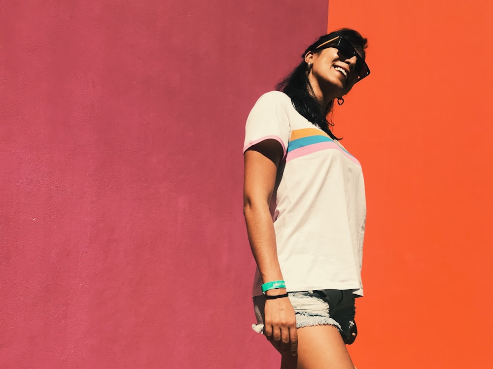 woman standing in front red and orange wall