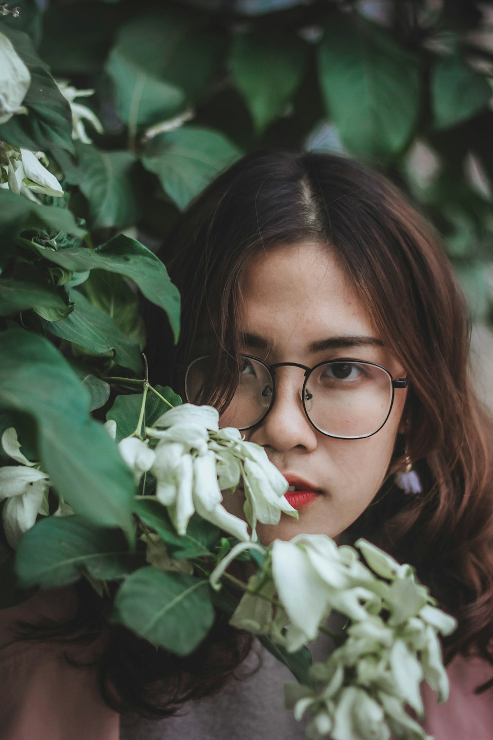 selective focus photo of woman near white flower