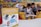 A children's encyclopedia about creativity is prominently displayed. The book features illustrations of space-related technology such as a satellite, space capsule, spacesuit, rocket, and a spectrograph on its cover. In the background, children are sitting on yellow cushioned seats, reading and engaging with each other. The wall behind them is decorated with a colorful mural of a cartoon-like scene.