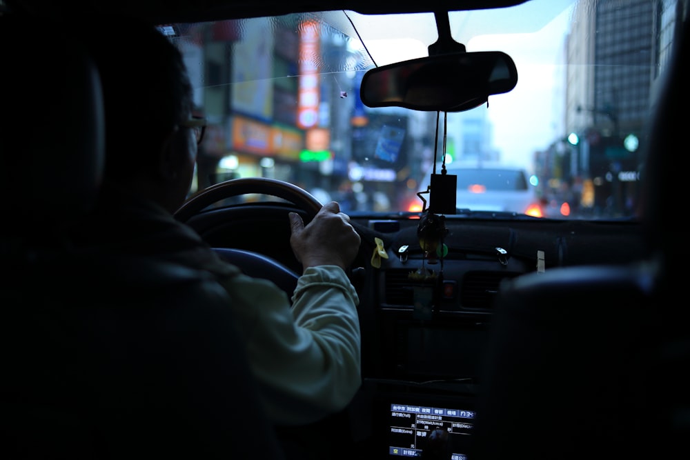 man driving car with bokeh lights