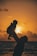 silhouette photo of man carrying baby during golden hour