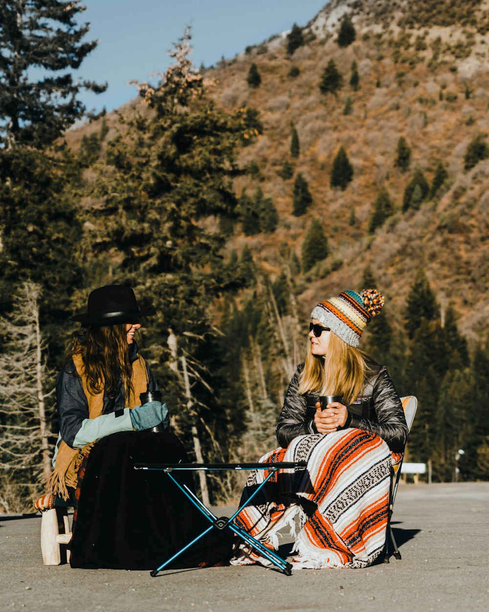 two women sits on chair outdoor