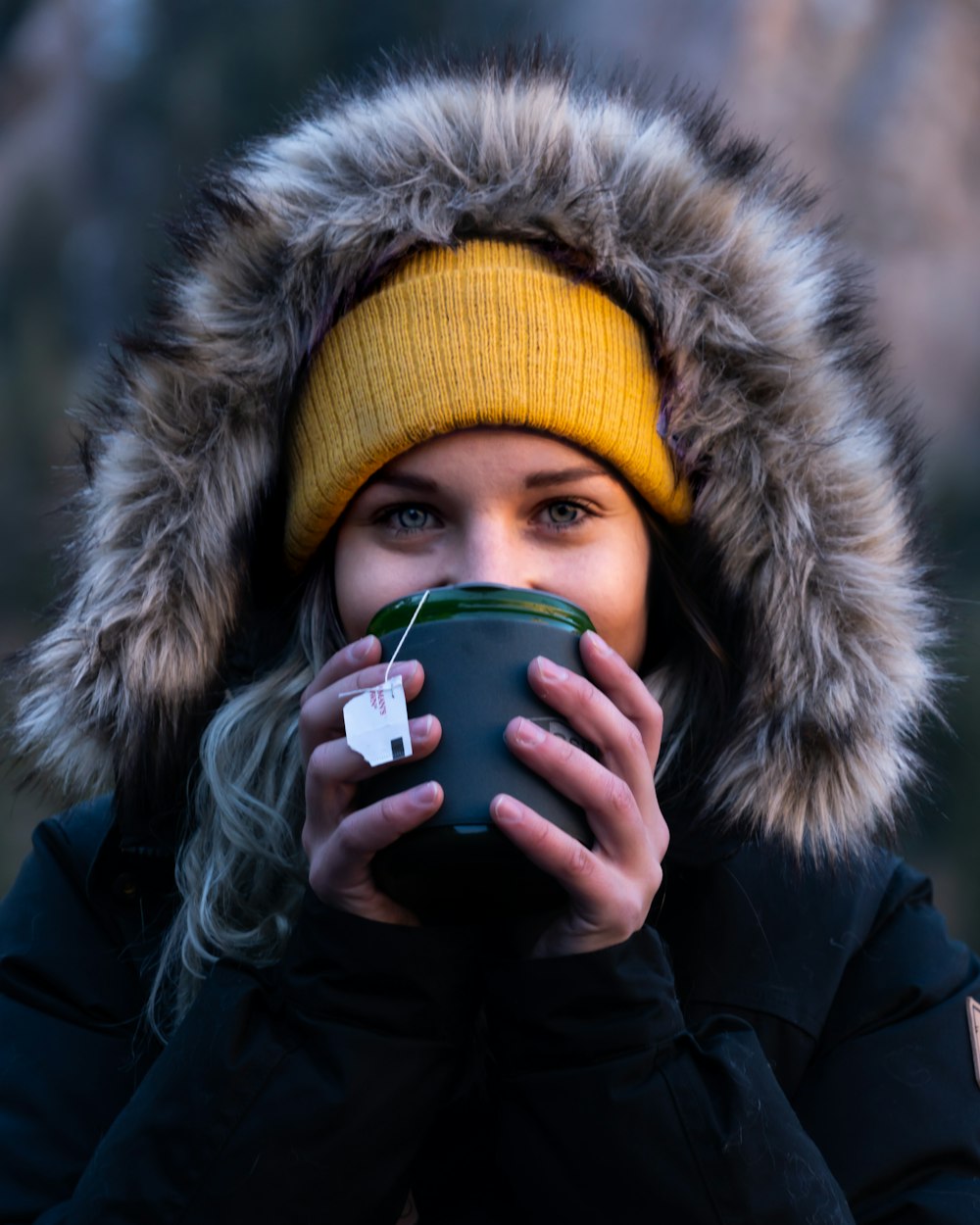 selective focus photo of woman zipping the cup