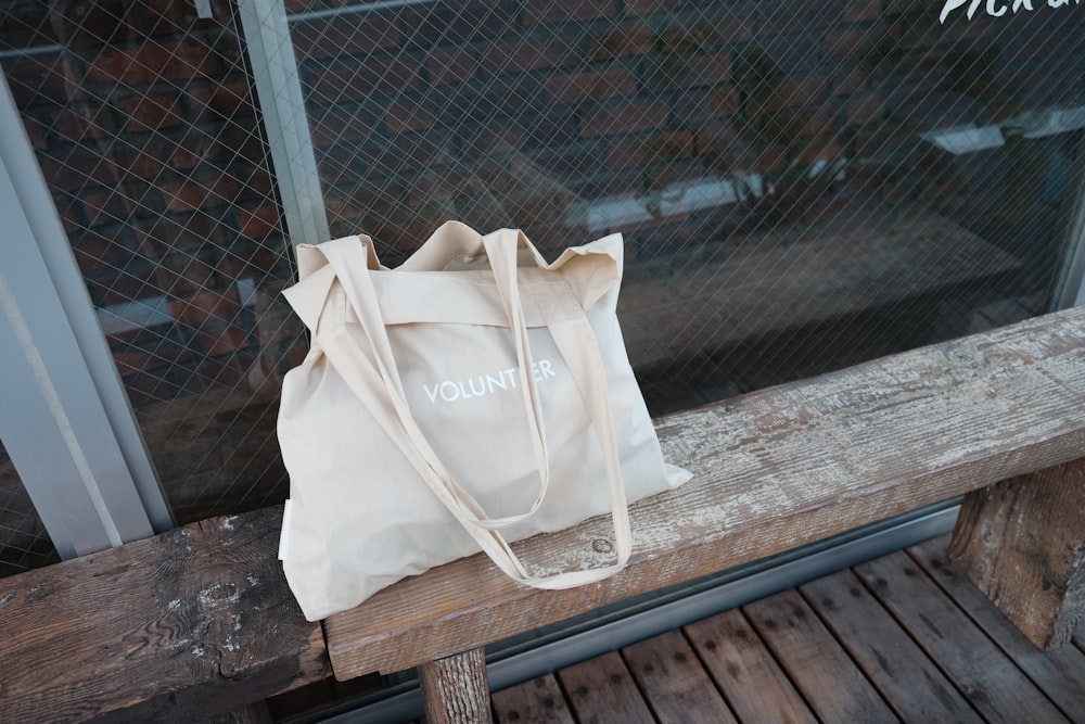 beige tote bag on bench