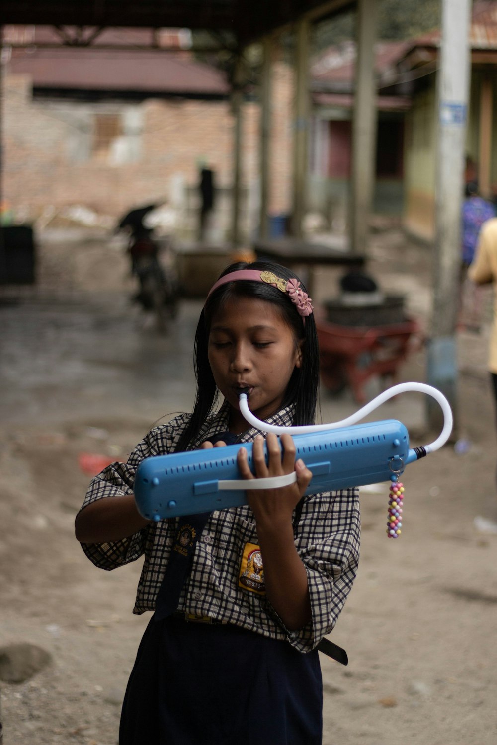 girl playing blue musical equipment