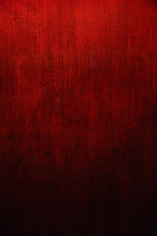 Polished red granite slab featuring deep crimson tones, against a minimalist background.