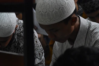 selective focus photo of man wearing taqiyah cap