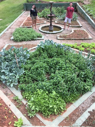 Nilesh Damodar Prabhu speaking warmly with local residents in a community garden.