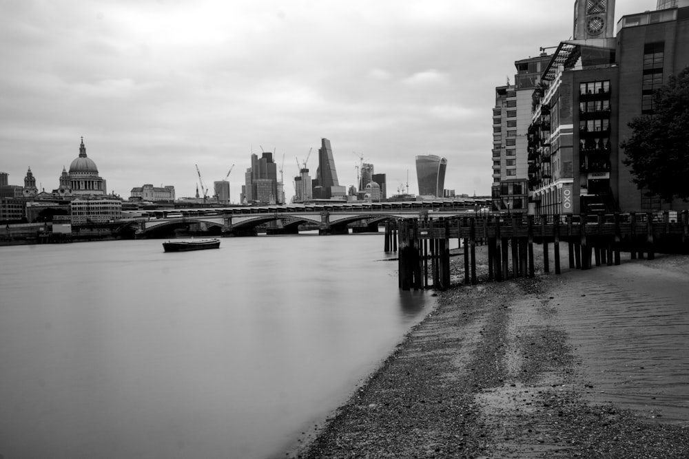 grayscale photography of wooden dock near body of water