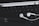 An arrangement of technological accessories featuring a keyboard, white earphones, a white stylus, and a smartphone with a visible logo on a dark background.