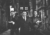 A group of men showcasing diverse outfits in an urban setting.
