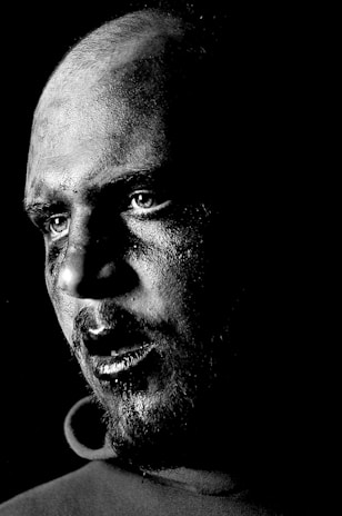 A striking black-and-white portrait capturing raw emotion and sharp contrast.