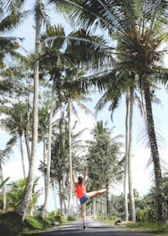 woman standing between trees during daytime