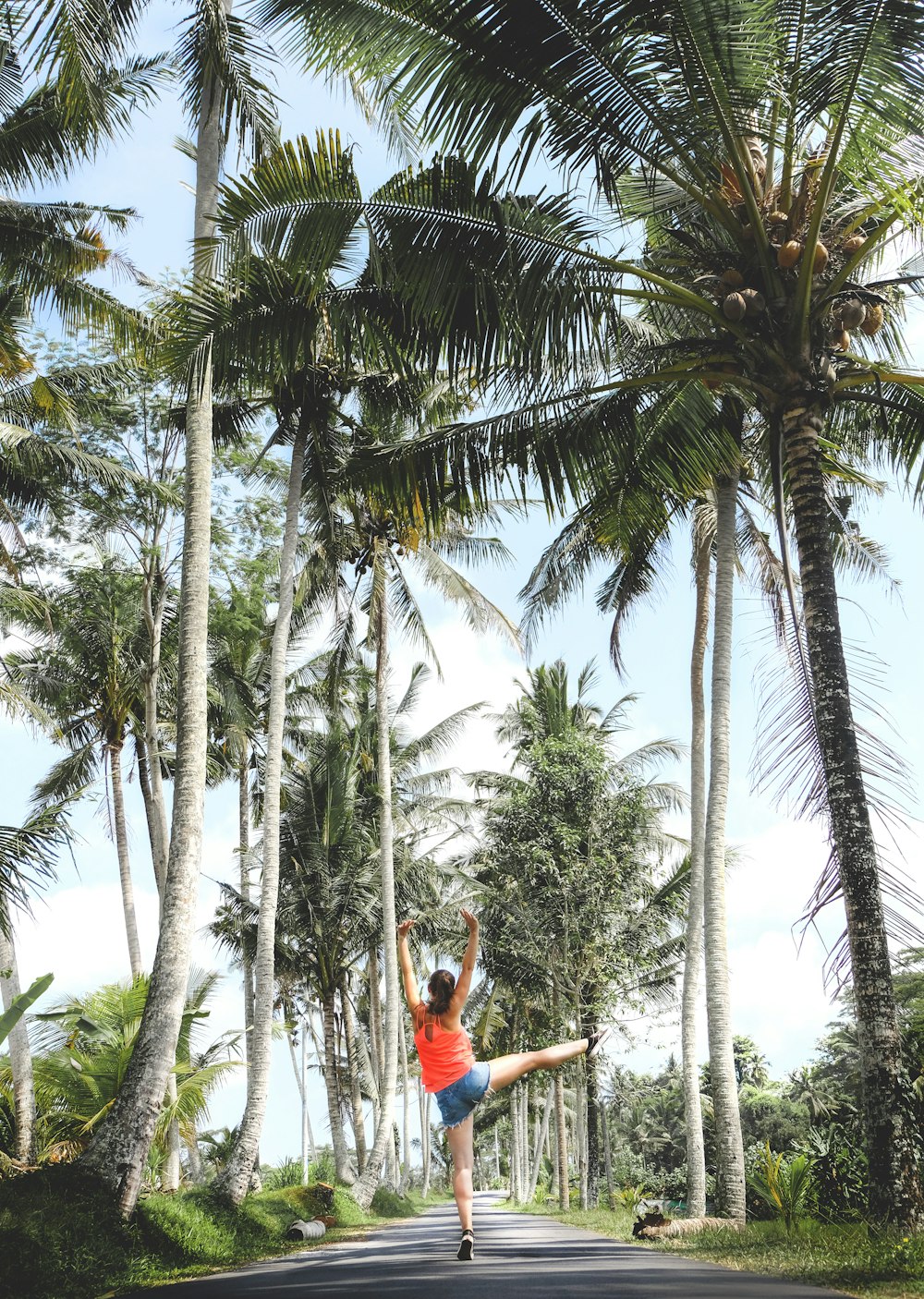 woman standing between trees during daytime