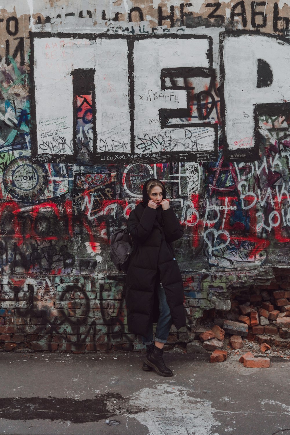 woman leaning on wall art