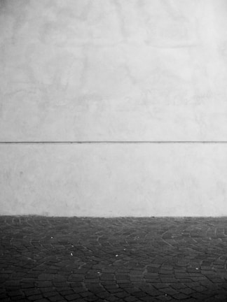 Close-up of a minimalist editorial layout with extreme typographic contrast in muted stone tones.