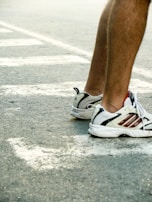 Close-up of a runner's feet pounding the pavement in vibrant red Sportshouse trainers.