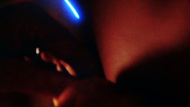 A close-up of a cinematic scene with striking warm and cool color contrasts.