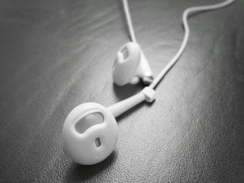 Close-up of sleek, modern headphones resting on a clean white surface.