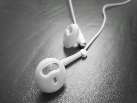Close-up of sweat-resistant headphones resting on a workout towel.