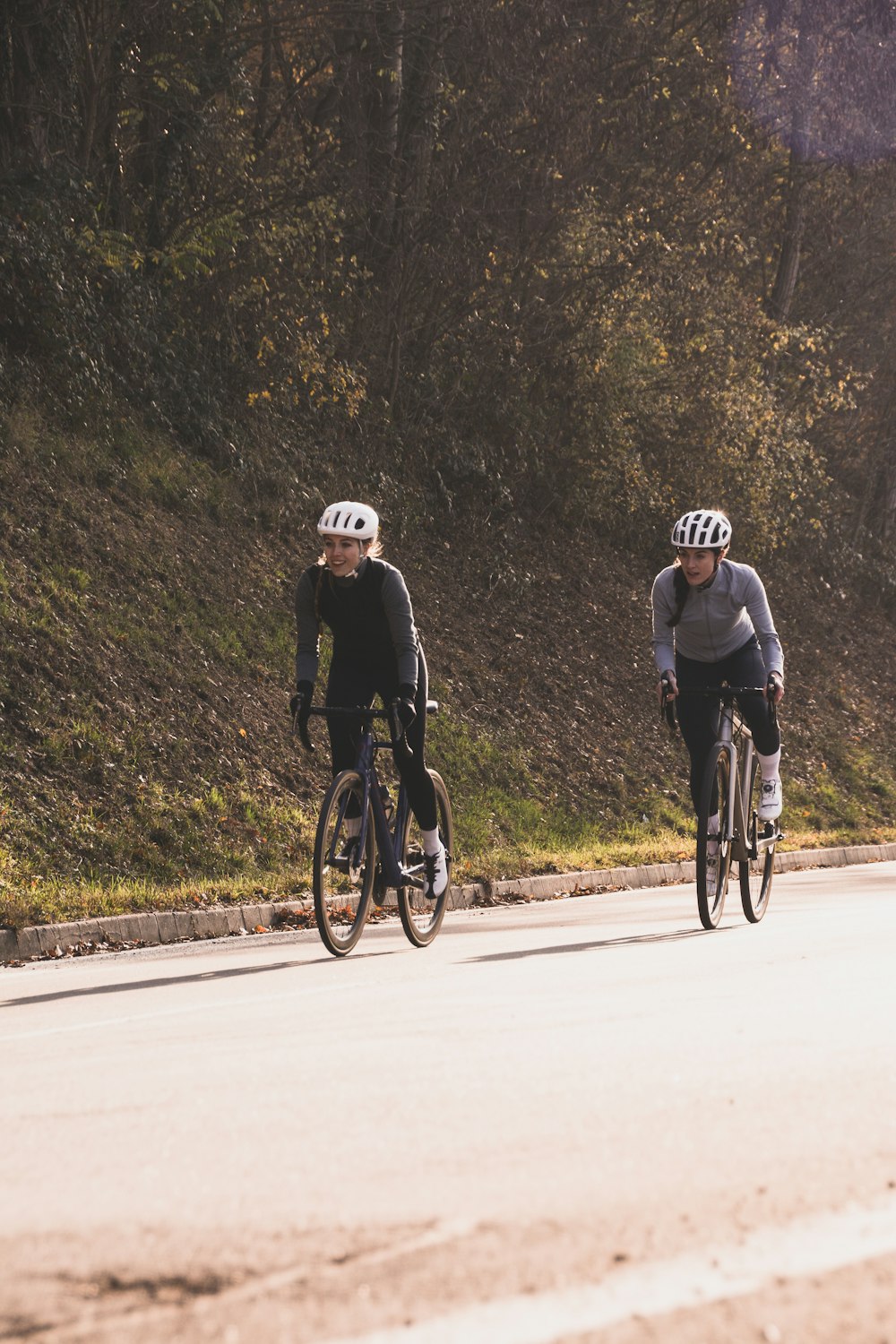 two people riding on bike uphill
