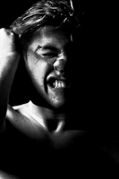 A high-contrast black and white portrait capturing intense human expression.