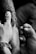 A close-up view of a tattoo being applied to someone's arm by a tattoo artist. The artist's hand is steady as they work on the intricate details of the design. The scene captures the intensity and focus required in tattooing.