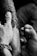 A close-up view of a tattoo being applied to someone's arm by a tattoo artist. The artist's hand is steady as they work on the intricate details of the design. The scene captures the intensity and focus required in tattooing.