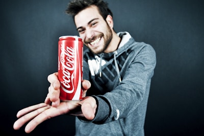 A confident man holding the Kriko product with a bold smile.