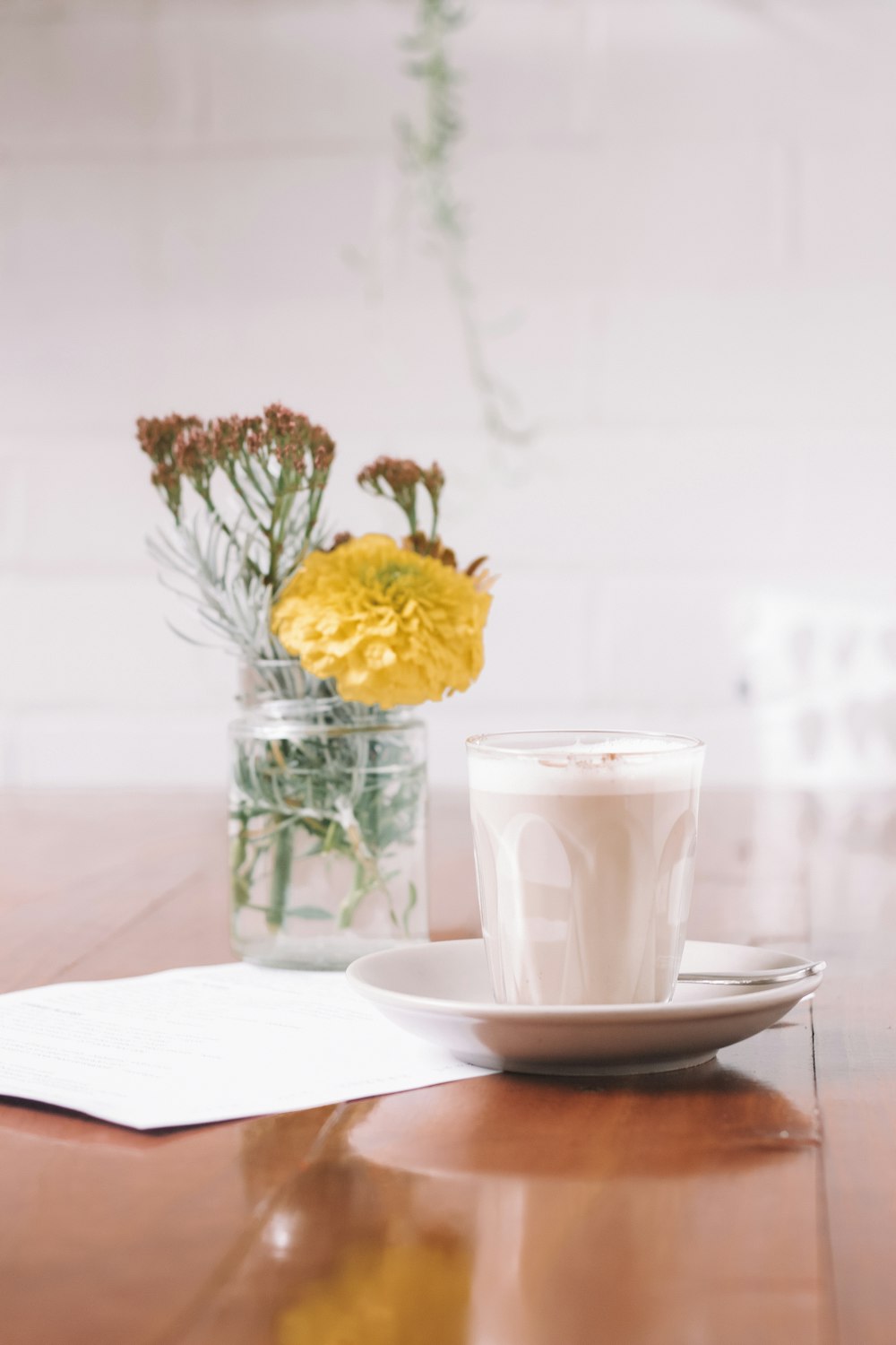 white drinking glass with saucer