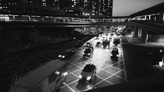 Wide shot of a busy urban environment within the game featuring multiple vehicles in motion.