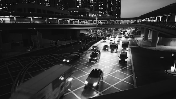 Wide shot of a busy urban environment within the game featuring multiple vehicles in motion.