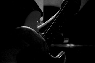 Black and white photo print of a classic rock guitar on a dark background